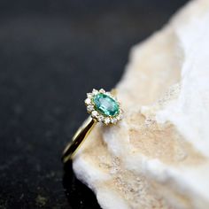 18K Emerald and Brilliant Diamonds Engagement Ring, 0.45ct Natural Emerald Gold Ring, 18K Brilliant Diamonds Wedding Ring, Gift For Her ⚜️Weight: 6.0gr   💎Gemstone: Emerald 0.45ct  💎Gemstone: 14 Diamonds of 0.15ct each Beautiful and unique 18K gold Diana emerald ring set with 1 emerald and 14 small diamonds.  🦚 Visit my gemstone rings collection:  https://www.etsy.com/shop/noahconcept/?etsrc=sdt&fbclid=PAAabX3la4ZzrGRug-fdx0AVTcM8lpjsQHSMDfEzyRu4du-woM_ISVKRQy-x4_aem_AX0rENIVkOuE6tb8lFnkZ-I7L1xhLyAzS9jU5bKkczHscuq2Zk93UMLbmGnlinC5MBA&section_id=43942909 The jewelry you buy from NoahConcept are delivered in ♻️ eco friendly boxes with the brand name on the top. If you want to wrapped as gift please let us know. *Small changes in the jewelry prices may occur depending on the price of the m Emerald Cluster Ring With Brilliant Cut Diamonds, Cluster Moissanite Ring With Halo Design, Cluster Halo Moissanite Rings, Emerald Ring With Marquise Cut Diamond Center Stone, Emerald Cut Halo Design Ring For Proposal, Yellow Gold Halo Design Cluster Rings, Fine Jewelry Emerald Ring With Halo For Anniversary, Emerald Ring With Diamond Halo Design, Yellow Gold Emerald Diamond Ring With Halo Design