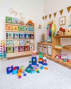 a child's playroom with toys and bookshelves on the floor in front of it