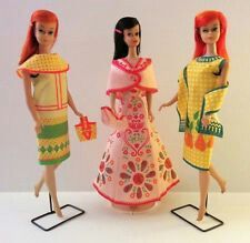 three barbie dolls are standing next to each other