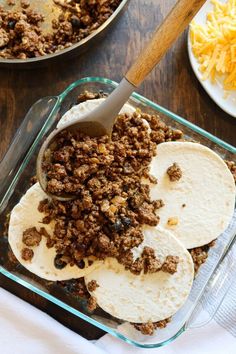 tortillas with ground beef and cheese in a casserole dish