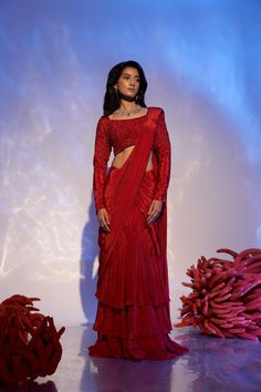 Embrace opulence with our exquisite Ruby Reef Drape Saree. Crafted from sumptuous red crepe silk, this alluring saree exudes elegance and allure. The heavy blouse adorned with intricate crystal beadwork and sparkling sequins adds a touch of glamour, making it a true statement piece. Immerse yourself in the luxurious fabric and unparalleled craftsmanship of this masterpiece, fit for a queen. Make a striking impression at any soirée or special occasion, as you gracefully drape yourself in the fine Elegant Red Silk Pre-draped Saree, Red Embellished Pre-draped Saree, Elegant Red Embellished Pre-draped Saree, Red Embellished Georgette Pre-draped Saree, Red Embellished Pre-draped Georgette Saree, Red Embellished Georgette Saree, Red Formal Blouse With Traditional Drape, Red Pre-draped Saree With Dupatta For Formal Occasions, Elegant Red Pre-draped Saree With Cutdana