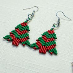 a pair of red and green beaded christmas tree earrings