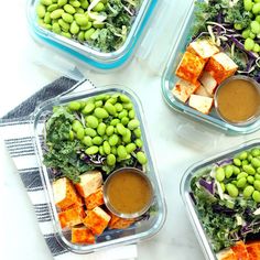 four plastic containers filled with vegetables and tofu