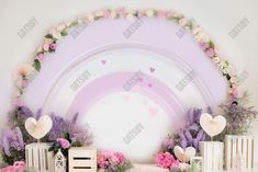 the backdrop is decorated with flowers and hearts