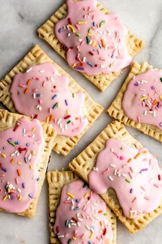 pink frosted donuts on top of waffles with sprinkles