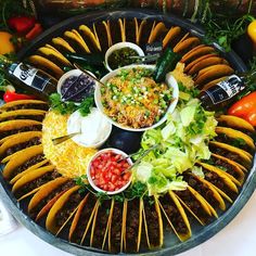 a platter filled with different types of food and condiments on top of it