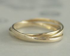 three gold wedding bands stacked on top of each other