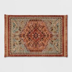 an orange and blue area rug on a white wall with a red border around it