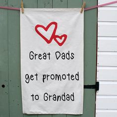 a sign hanging on the side of a building that says great dads get promote to grandad