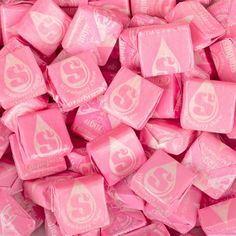 a pile of pink candy with white letters on it