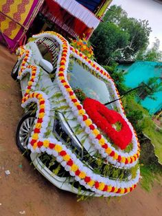 the car is decorated with flowers and garlands