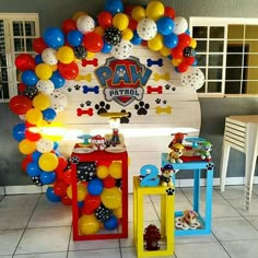 a birthday party with balloons and decorations for paw patrol themed birthdays on the table