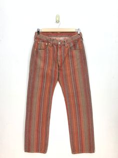 Vintage Levis Jeans Red Stripe Levis 501 Denim Pants - BS47597.  Manual Measurement (laying in flat area):  1) Waist: 34 inch.  2) Rise: 10.5 inch.  3) Hips: 22.5 inch.  4) Tight: 12 inch.  5) Outseam: 44 inch.  6) Inseam: 33 inch.  7) Leg opening: 9 inch.  Made in: JAPAN.  Fabric Material: 100% Denim Cotton.  Condition: In good vintage condition overall.  Please check all the measurement to insyre a proper fit.  Remember to allow yourself some extra room for movement.  You can compare these information with your favourite pants too.  BS47597.  We do combining shipping.  Please Read Before Purchase. Drop your phone number. Tracking number can be tracked 3 - 5 days after shipment process. Please be patient waiting. This design and style by wearing it increases your confidence. All pieces ar Pants Levis, Levis Boyfriend Jeans, 90s Women, Levis 569, Levis Pants, Vintage Levis Jeans, Girlfriend Jeans, Striped Jeans, Levi's 501