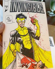 a person holding up a comic book with an image of a man dressed as wolverine