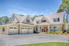 a large white house with two garages on the front