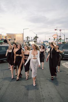 a group of women walking down the street