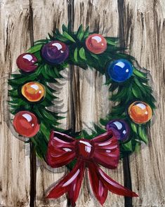 a painting of a christmas wreath on a wooden fence with red ribbon and balls painted on it