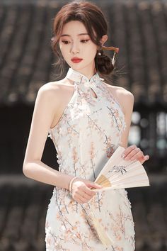 Take your summer outfit to the next level with this sleeveless qipao in white color. Its sleeveless style adds a touch of charm and allure to the white qipao dress. The beautiful neckline with a mandarin collar will gracefully accentuate your shoulders. Floral Print Sleeveless Dress For Wedding, Sleeveless Cheongsam For Evening, Elegant Sleeveless Fitted Ao Dai, Elegant Sleeveless Fitted Cheongsam, Elegant Sleeveless Ao Dai For Wedding, Sleeveless Spring Wedding Cheongsam, Spring Wedding Sleeveless Cheongsam, Elegant Floral Print Cheongsam For Spring, Elegant Floral Print Spring Cheongsam