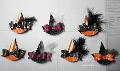 several different types of hair clips with polka dots and bows on them, all decorated in orange and black