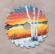 a painting of trees in the snow on a piece of paper with a hole cut into it