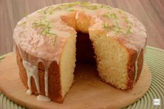 a cake that has been cut in half and is on a wooden platter with one slice taken out