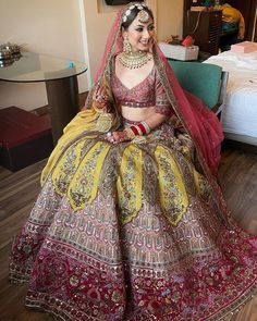 a woman in a yellow and red bridal gown