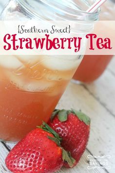 some strawberries are sitting on the table next to a mason jar with strawberry tea in it