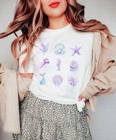 Our watercolor sea creatures tee makes for a cute addition to your everyday look. This classic unisex tee features short sleeves, a ribbed knit crew neckline, and a crustaceancore  inspired custom graphic on the front.  * S I Z I N G * ❥ Please see listing for image with dimensions ❥ Unisex Sizing so it runs a touch loose ❥ Runs true to size * T E E * C O N S T R U C T I O N * ❥ Solid colors are 100% airlume combed and ring-spun cotton ❥ Heather colors are 52% combed and ring-spun cotton, 48% polyester ❥ Soft and light with just the right amount of stretch ❥ Pre-shrunk fabric * C A R E * I N S T R U C T I O N S * ❥ Machine wash cold, inside-out, gentle cycle with mild detergent and similar colors.  ❥ Use non-chlorine bleach, only when necessary. No fabric softeners. ❥ Tumble dry low, or ha Cotton Mermaid Top For Summer, Cute Beach Season Shirt, Summer Fish Print Crew Neck Tops, Summer Crew Neck Top With Fish Print, Coconut Girl Clothes, Blush Aesthetic, Aesthetic Mermaid, Mermaid Top, Mermaid Shirt