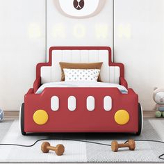 a bed with mickey mouse ears on the headboard and foot board in a child's bedroom