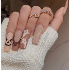 a woman's hands with halloween themed nail art on their nails and manies