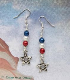 the earrings are decorated with red, white and blue beaded stars on silver earwires