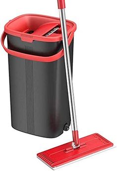 a red and black dustbin with a mop next to it