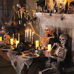 a table topped with skeletons and candles