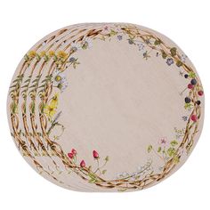 four round placemats with flowers and vines on the edges, all in different colors