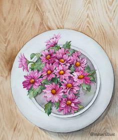 a painting of pink daisies in a white bowl on a wooden surface with green leaves