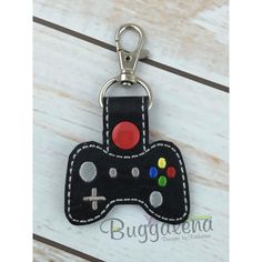 a leather key chain with a game controller on it