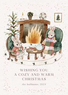 a christmas card with two bunnies sitting in chairs next to a fireplace and the words wishing you a cozy and warm christmas