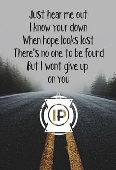 an empty road with the words just hear me out i know your down when hope looks lost there's no one to be found but it won't give up on you