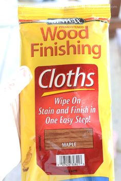 a bag of wood finishing cloths sitting on top of a person's hand