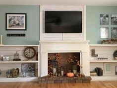 a living room filled with furniture and a flat screen tv mounted on the wall above a fire place