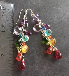 "I created these colorful dangles to celebrate being a jewelry designer for 12 years! Thank you to all of my wonderful customers for the support! These are made in sterling silver wire with amethyst, citrine, quartz, fire moonstone and more! The apprx. length is 2.5\" . Sterling silver wiring and French Ball earwires. Your earrings will be beautifully gift boxed. (To see VIDEO of these earrings please visit my instagram, @Sueanneshirzay August 12 2020 )" Multicolor Sterling Silver Party Earrings, Multicolor Sterling Silver Earrings For Party, Long Drop Multi-stone Earrings For Gift, Party Multicolor Sterling Silver Earrings, Handmade Colorful Jewelry For Birthday, Whimsical Rainbow Dangle Jewelry, Dangle Multi-stone Earrings For Gifts, Multi-stone Dangle Earrings For Party, Handmade Dangle Jewelry For Birthday