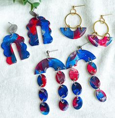 Add a touch of creativity to your game day outfit with our beautiful hand painted polymer clay earrings. Handmade with meticulous attention to detail, these unique hand painted red, white and blue earrings offer a blend of style and comfort for those who appreciate fun statement jewelry. Designed with surgical steel findings, our earrings cater to those with sensitive ears, ensuring everyone can enjoy these stunning accessories while cheering on their favorite teams. These cute earrings are espe Whimsical Hand Painted Blue Earrings, Whimsical Blue Hand Painted Earrings, Red Hand Painted Polymer Clay Earrings, Hand Painted Red Polymer Clay Earrings, Fun Blue Hand Painted Earrings, Fun Hand Painted Blue Earrings, Whimsical Blue Polymer Clay Earrings, Handmade Blue Craft Supplies For Gifts, Playful Blue Craft Supplies For Gifts