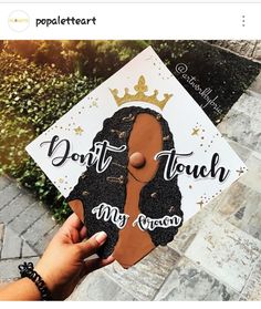 someone is holding up a graduation cap with the words don't touch my crown on it