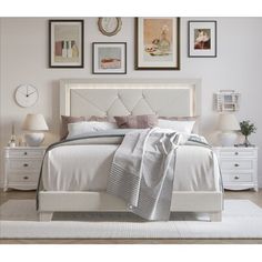 a bedroom with white furniture and pictures on the wall above it, including a bed