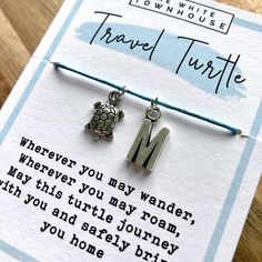 two little turtle bracelets on a card that says travel turtle wherever you may wonder, but this turtle journey you and safely bring