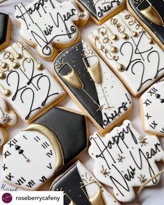 decorated cookies with black and white icing are arranged on a table together for a new year's eve celebration