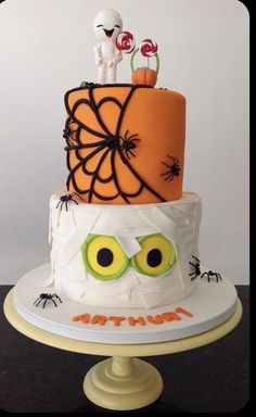 a three tiered cake decorated with halloween decorations