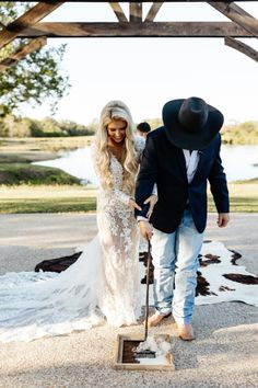 the bride and groom are dressed in cowboy attire