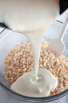 a bowl filled with oatmeal and milk being poured into it