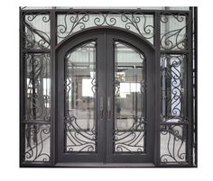 an ornate iron double door with glass panels and wrought designs on the front entrance to a building